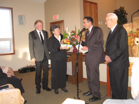 Pastors Warren Kay and Bill Wigley present a token of appreciation to Harold and Violet Holdal for their time and energy.